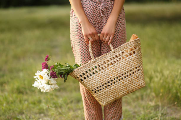 istock Girl with wicked basket in summer park 981879906