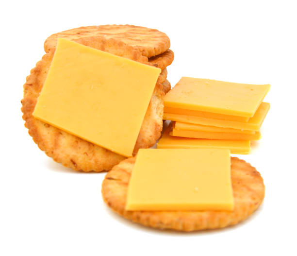 istock Delicious crackers with cheese on white background 981884062