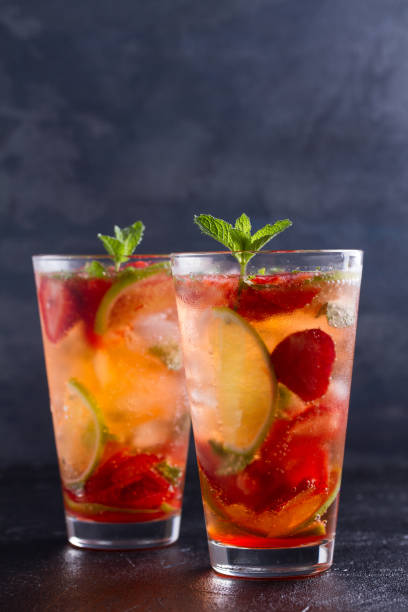 istock Strawberry mojito cocktail with berries, lime, mint and ice, black background 981888214