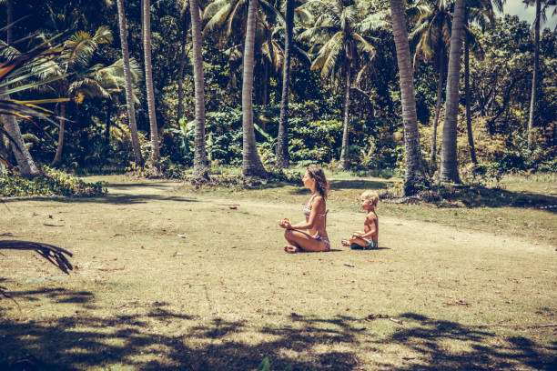 istock Woman and boy practicing yoga 981888534