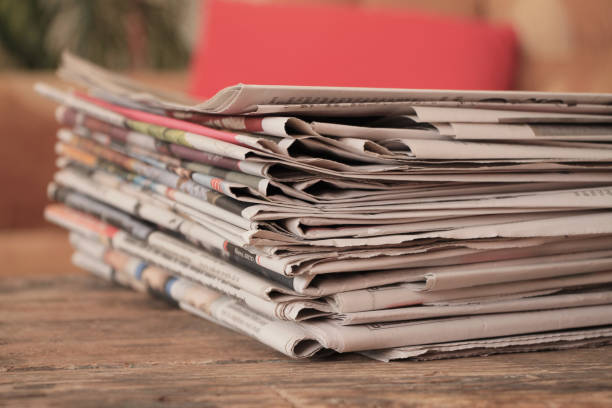 istock Old newspapers on wooden table 981888700