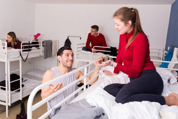 istock Man discussing with female in hostel 981893478