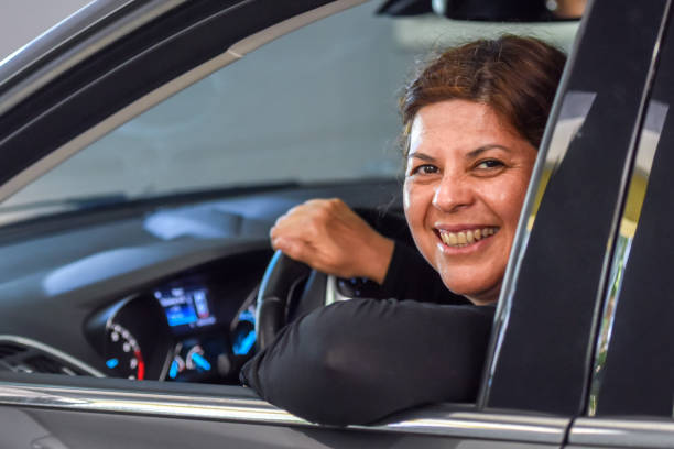 istock Smiling mature woman driving her car 981897752