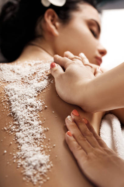 istock woman receiving massage with salt peeling 981902188