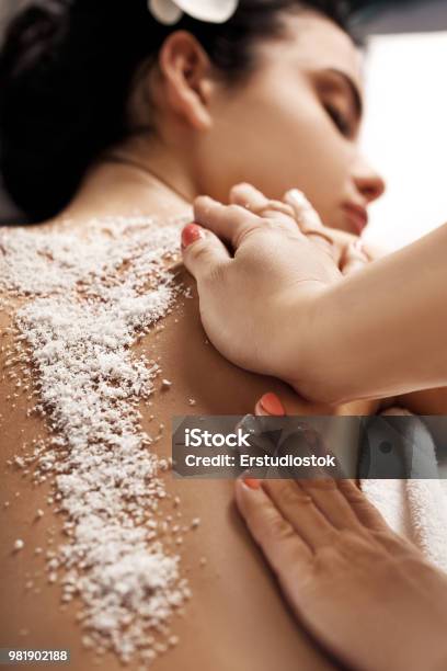 Woman Receiving Massage With Salt Peeling Stock Photo - Download Image Now - Exfoliation, Spa, The Human Body