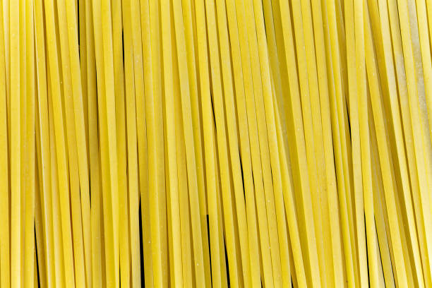 istock Close up top view of raw spaghetti pasta background 981923192