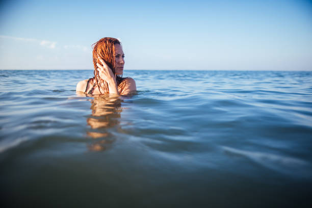 istock Woman having fun in sea 981926578