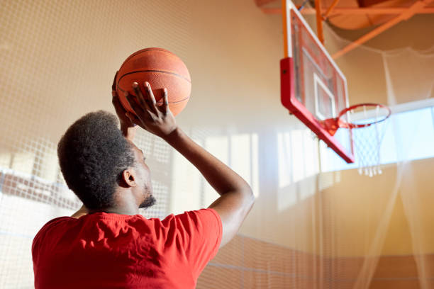 istock Black man throwing basketball ball 981937776