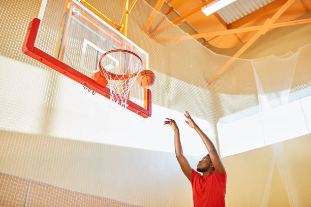 istock Black man shooting ball into basket 981937810