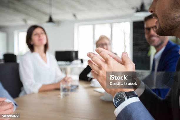 Businessman In Meeting With Colleagues In Office Stock Photo - Download Image Now - Adult, Board Room, Brainstorming