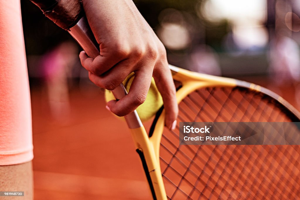 She's going to be a tennis star Close Up of Female Player Hand Holding Tennis Racket on Court. Cropped Shot of Woman Holding a Tennis Racket at the Court Tennis Stock Photo