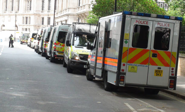 British Police Land Vehicle Packed In Westminster London England. Europe View Of British Police Officers Standing Talking To One Another And Packed Police Land Vehicle In Westminster London England Europe riot police stock pictures, royalty-free photos & images