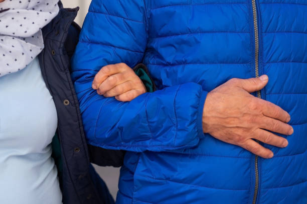istock Mature couple holding hands during walk. No face 981950284