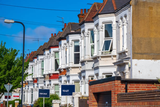 British terraced houses in London with estate agent boards A row of typical British terraced houses around Kensal Rise in London with estate agent boards houses for sale stock pictures, royalty-free photos & images