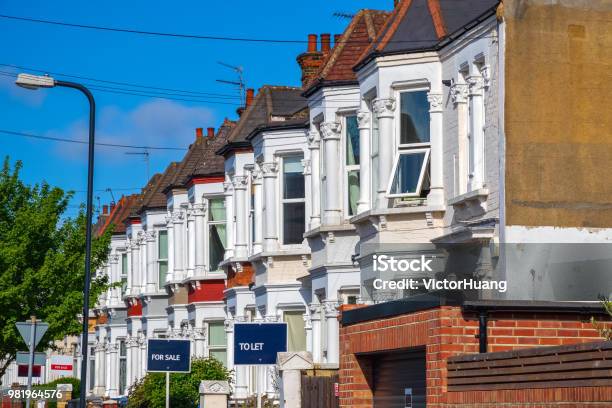 British Terraced Houses In London With Estate Agent Boards Stock Photo - Download Image Now