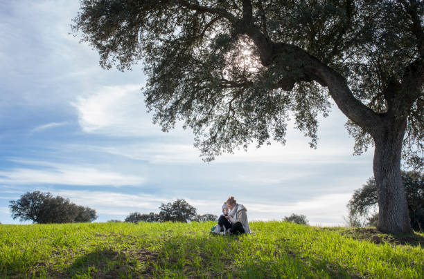 istock Mother and son playing with mobile at nature 981969388