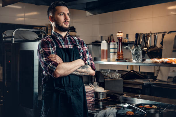 istock Portrait of stylish cook on a kitchen. 981974140