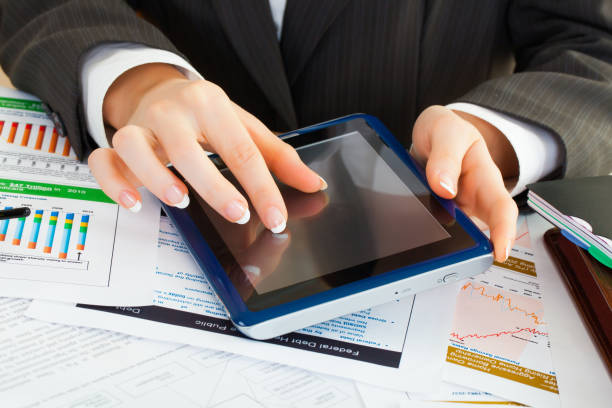 istock young business woman hands in office holding tablet pc 981977638