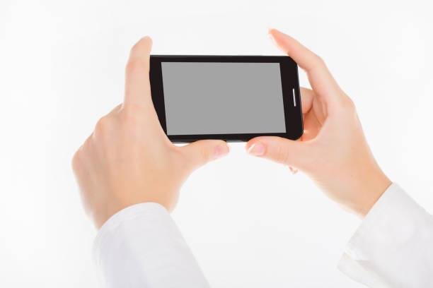 istock female hand is holding a modern touch screen phone. Screen is cut with clipping path 981978240