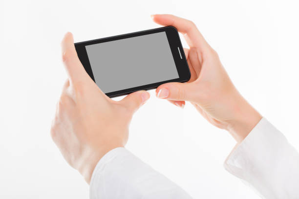 istock female hand is holding a modern touch screen phone. Screen is cut with clipping path 981978264