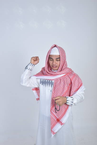 istock Muslim man holding prayer beads and praying 981978560