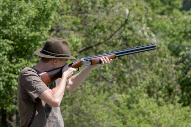 istock Young hunter with a hut on aiming to shoot 981988604