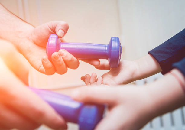 istock Hands with dumbbells. Sport equipment practice 981992332