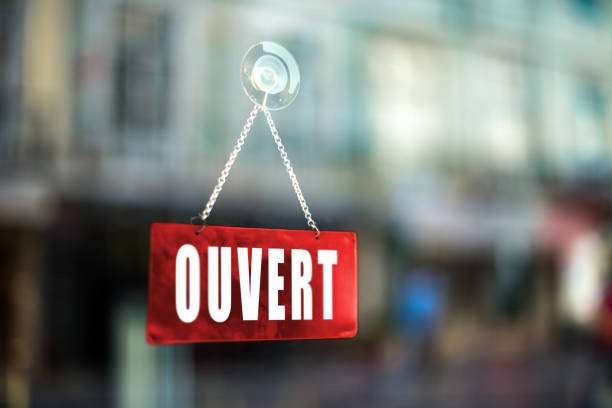Ouvert Open sign in French language Open sign in French language on glass storefront french language photos stock pictures, royalty-free photos & images