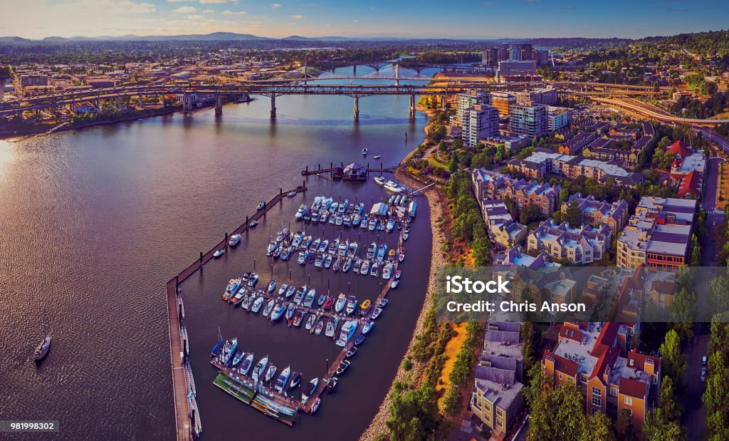 Aerial of Downtown Portland at Tom McCall Waterfront Park overlooking the Marina on early sunny morning with Tilikum Crossing Bridge in the distance Portland - Oregon Stock Photo