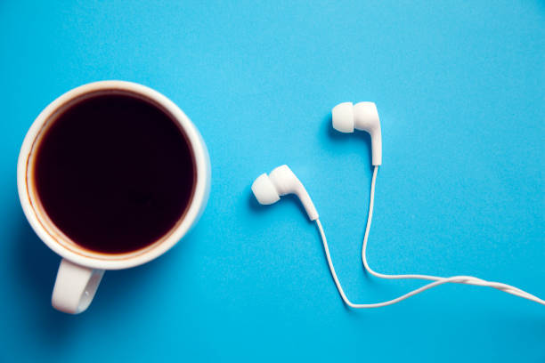 istock earphone and cup of coffee 981998352
