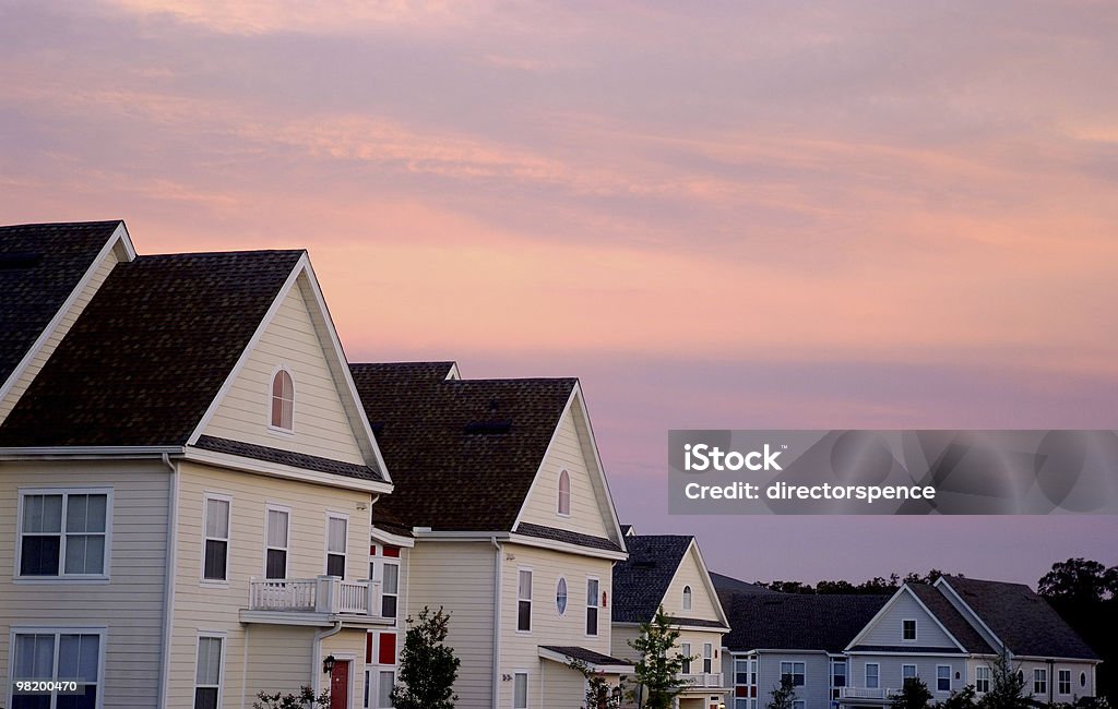 Pink Cloud Sunset over Townhouse Rooftops  Apartment Stock Photo