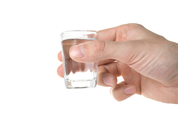 istock Hand holding a glass with vodka. 98200503