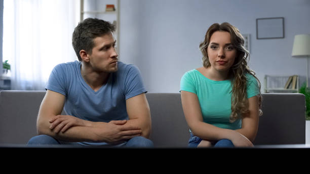istock Stubborn girlfriend ignoring her guy silently watching tv, relationship crisis 982014762