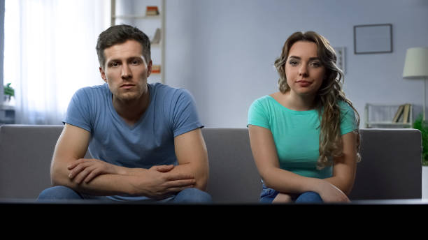 istock Relationship crisis, boyfriend and girlfriend watching tv ignoring each other 982014806