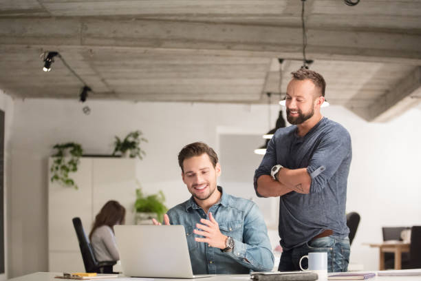 istock Happy businessmen working together in office 982024628