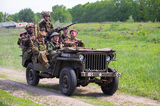 Kiev, Ukraine - May 09, 2018: Men in the uniform of American and British soldiers on a jeep during historical reconstruction in honor of the anniversary of victory in the Second World War