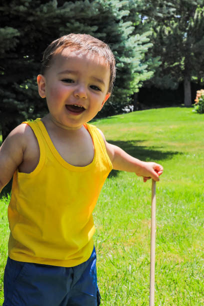 An ax in female hands on a blurred wall background. Old ax with rust close-up. Hand tools for repair and construction. Close-up of an ax in a woman's hand