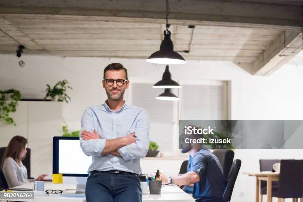 Entrepreneur At His Startup Office Stock Photo - Download Image Now - Adult, Adults Only, Arms Crossed