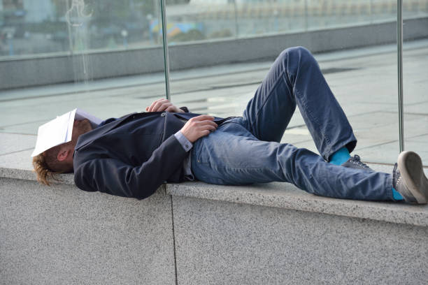 istock dismissed employee sleeps on the street 982047204
