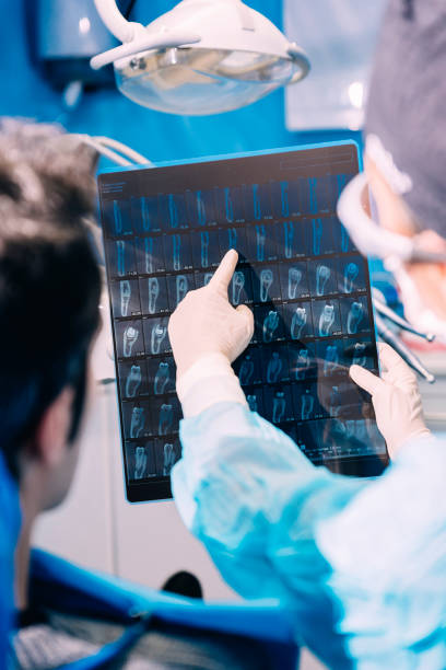 istock Doctor talking with her patient and teaching a radiography. 982047418
