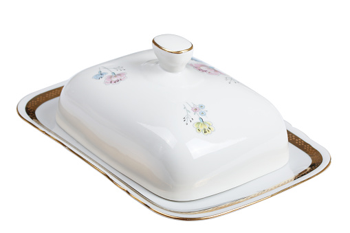 White porcelain butter dish with painted flowers isolated on a white background