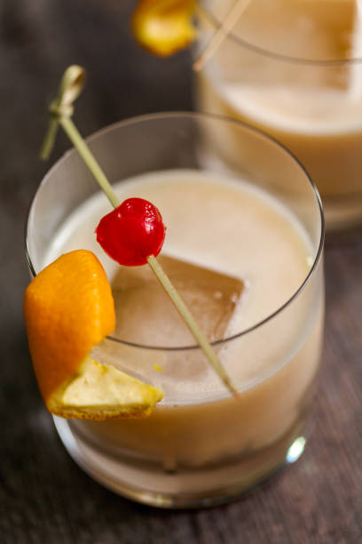 istock Whiskey sour cocktail garnished with orange and cherry. 982054208