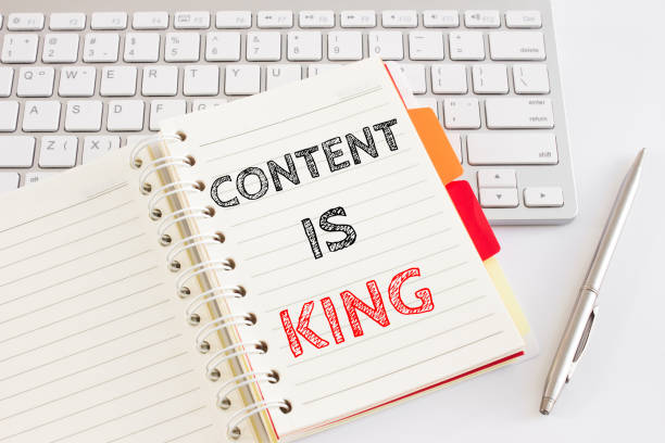 istock Word text Content is king on white paper card on office table / business concept 982060914