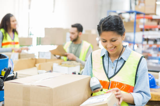 istock Confident warehouse employee prepares package for shipment 982090422
