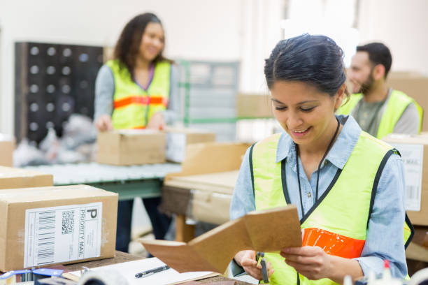 istock Female warehouse employee prepares customer order 982090424