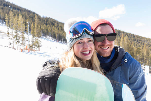 istock Joyful young couple enjoy ski holiday 982090566