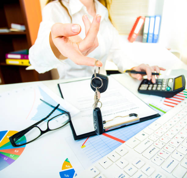 istock A woman's hand holds car keys and electronic door unlock in office 982094080