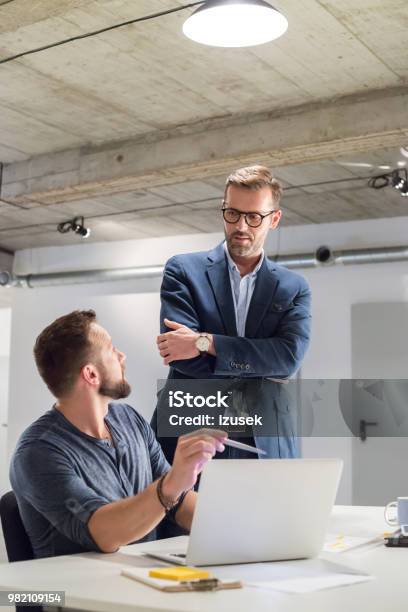 Businessman Discussing Over New Project In Office Stock Photo - Download Image Now - Adult, Adults Only, Beard