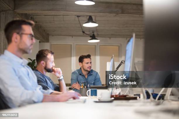 Team Of Designers Working At Desks In Modern Office Stock Photo - Download Image Now