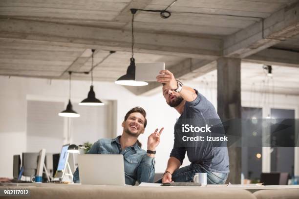 Businessmen Taking A Selfie In Office Stock Photo - Download Image Now - Symbols Of Peace, Indoors, Men